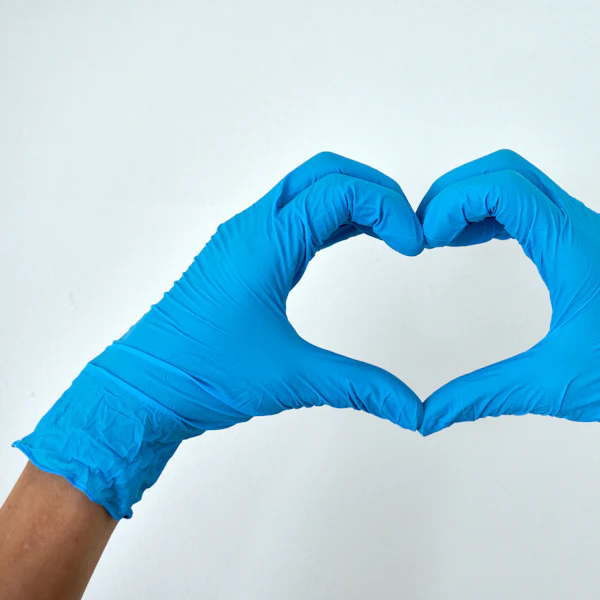 Hands in cleaning gloves making a heart shape