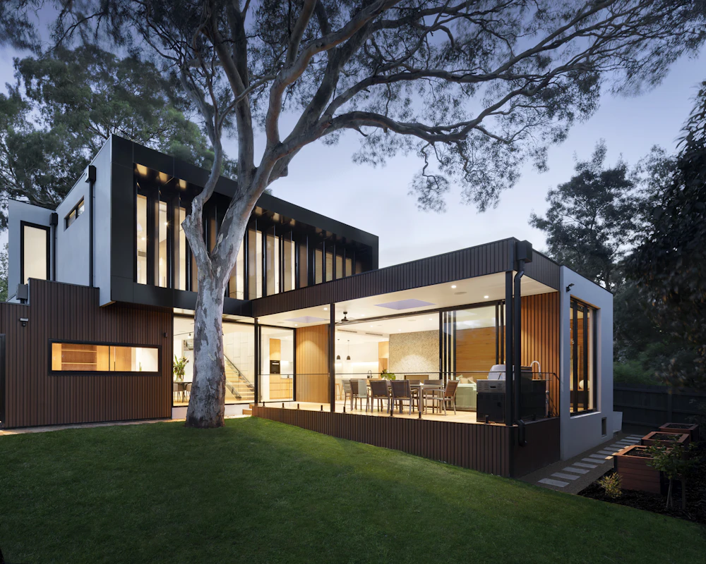 Modern detached house with a well-kept lawn at dusk